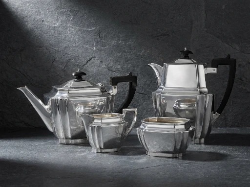 An Art Deco sterling silver tea service with angular handles and stepped form