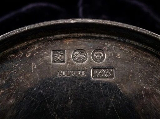 Maker's marks struck on the base of a piece of Chinese export silver