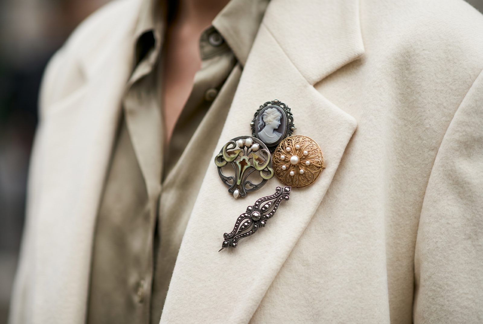 Stacked antique brooches on a blazer lapel — the most fashion-forward way to wear a brooch in 2026
