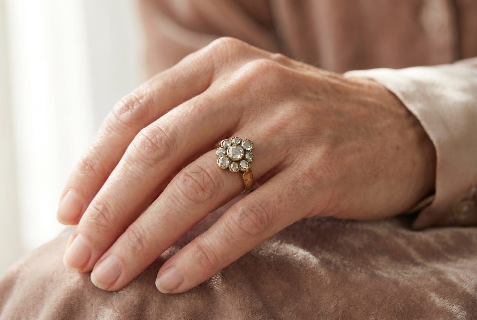Old cut diamond — an antique old-cut diamond cluster ring on the hand