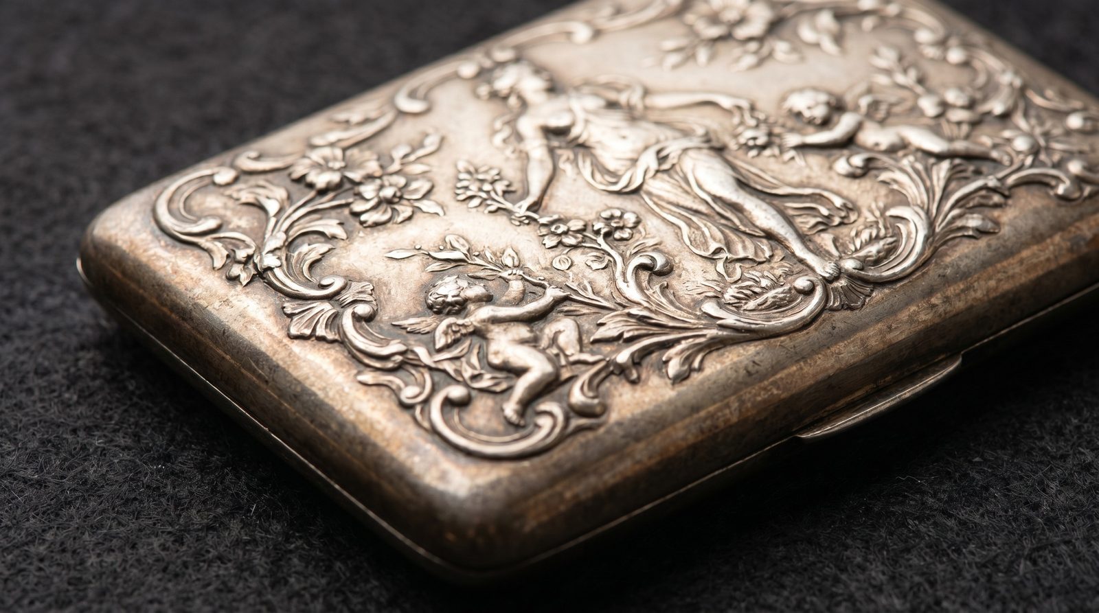 High-relief engraved scene on an antique silver card case