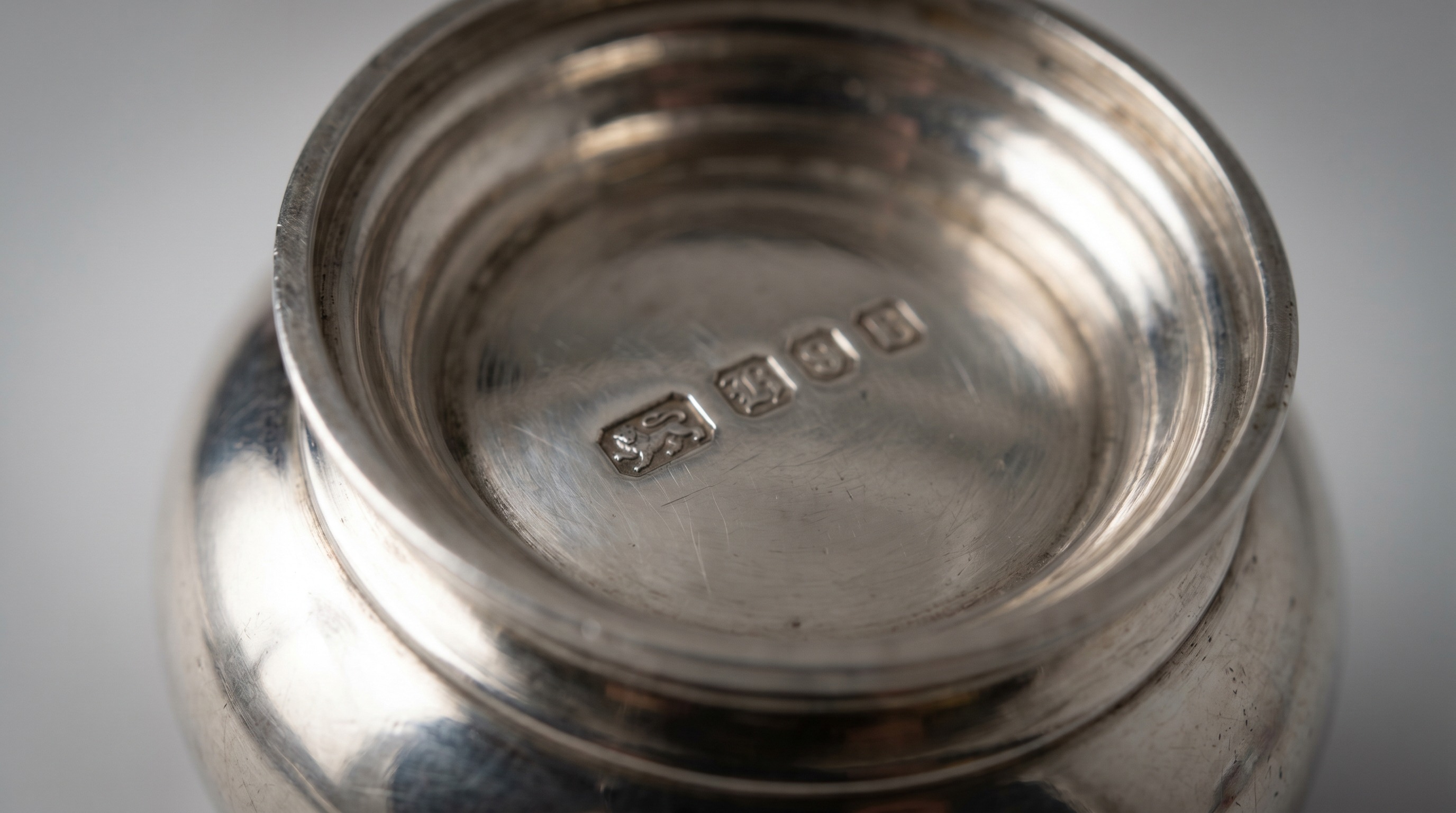 British silver hallmarks on the base of an antique condiment piece