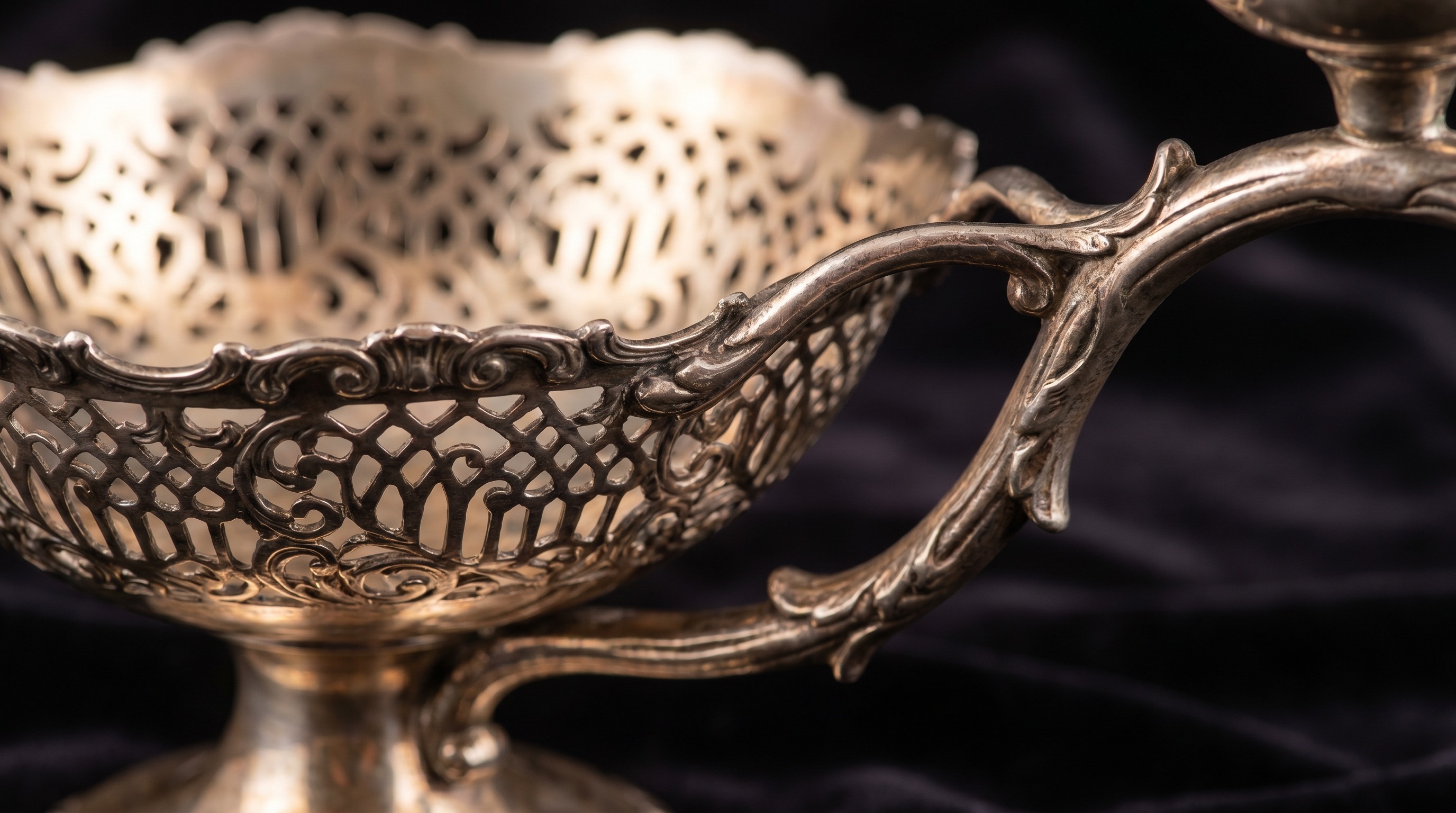 Close-up of a pierced silver basket on an antique epergne