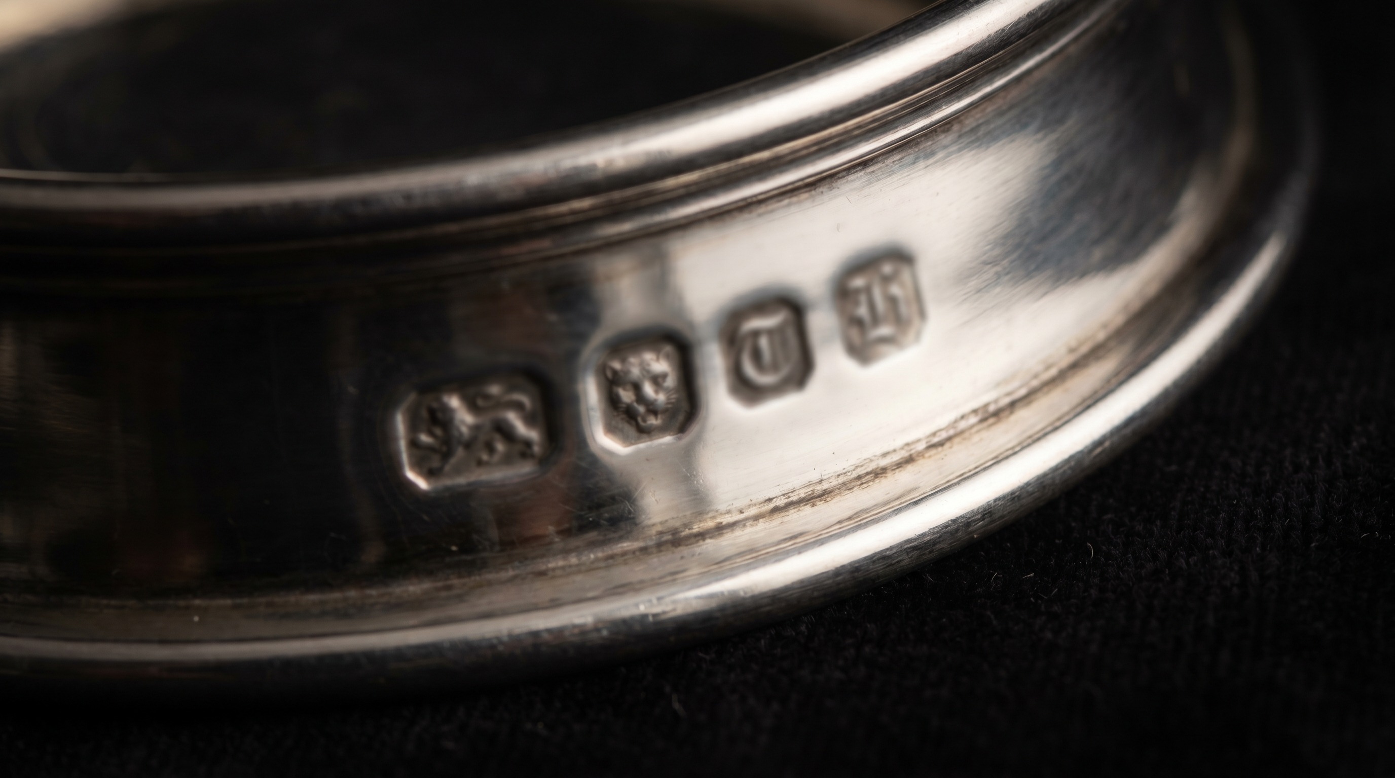 British silver hallmarks on the rim of an antique wine coaster