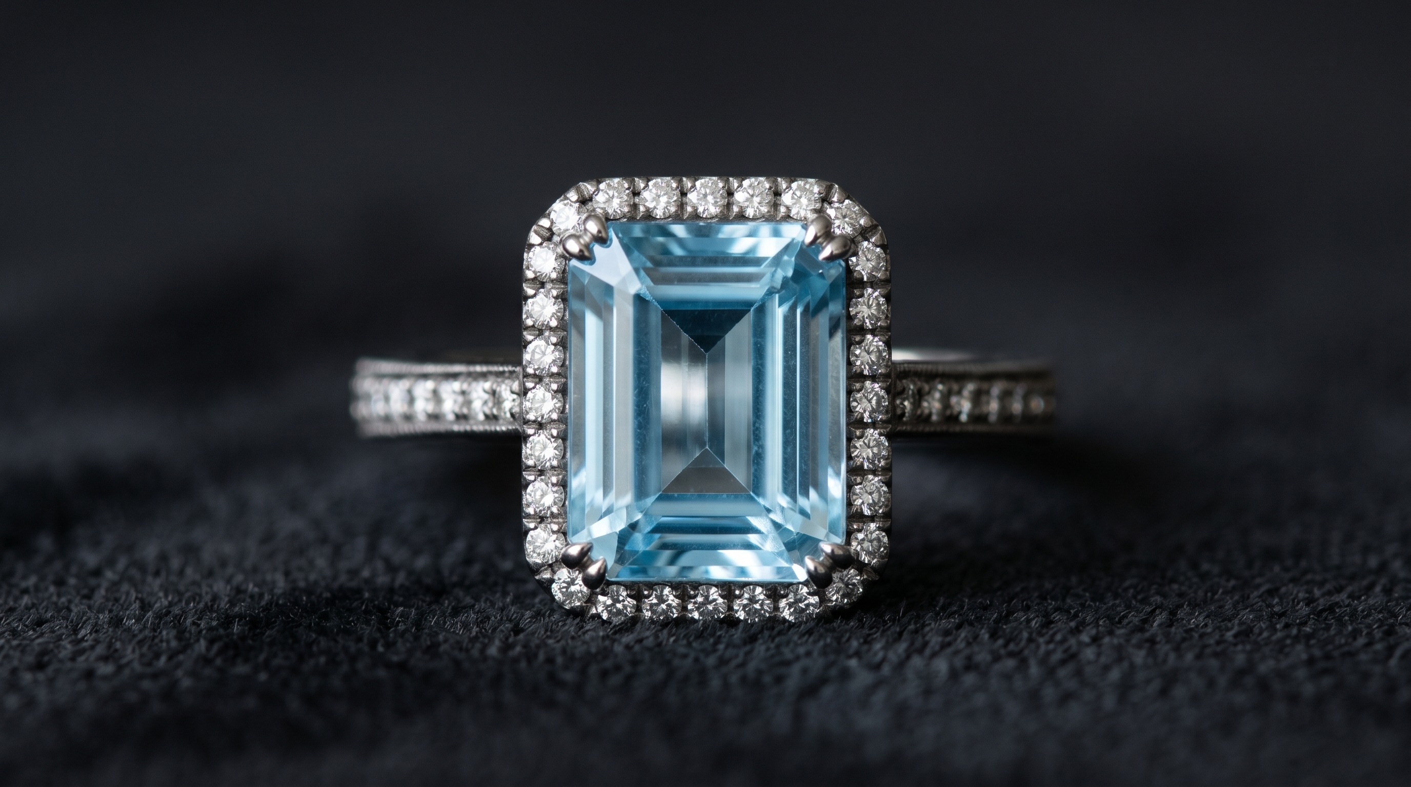 Macro of a clear sky-blue aquamarine, emerald-cut, set with diamonds in an antique mount