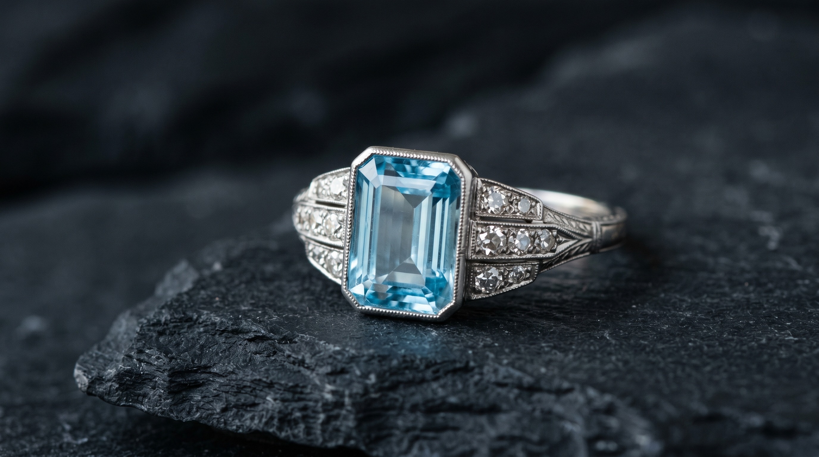 Antique aquamarine and diamond ring, the March birthstone, on a dark editorial background