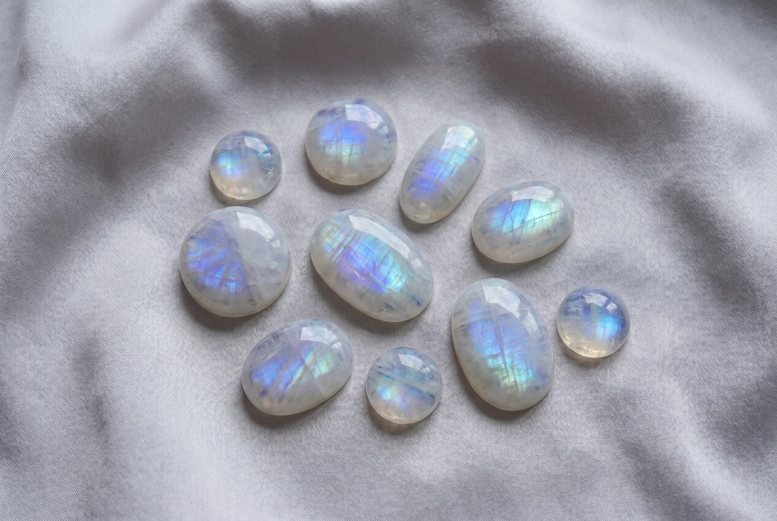 Loose moonstone cabochons with blue and rainbow sheen