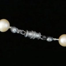 Antique silver barrel clasp connecting pearl strands, cylindrical screw mechanism