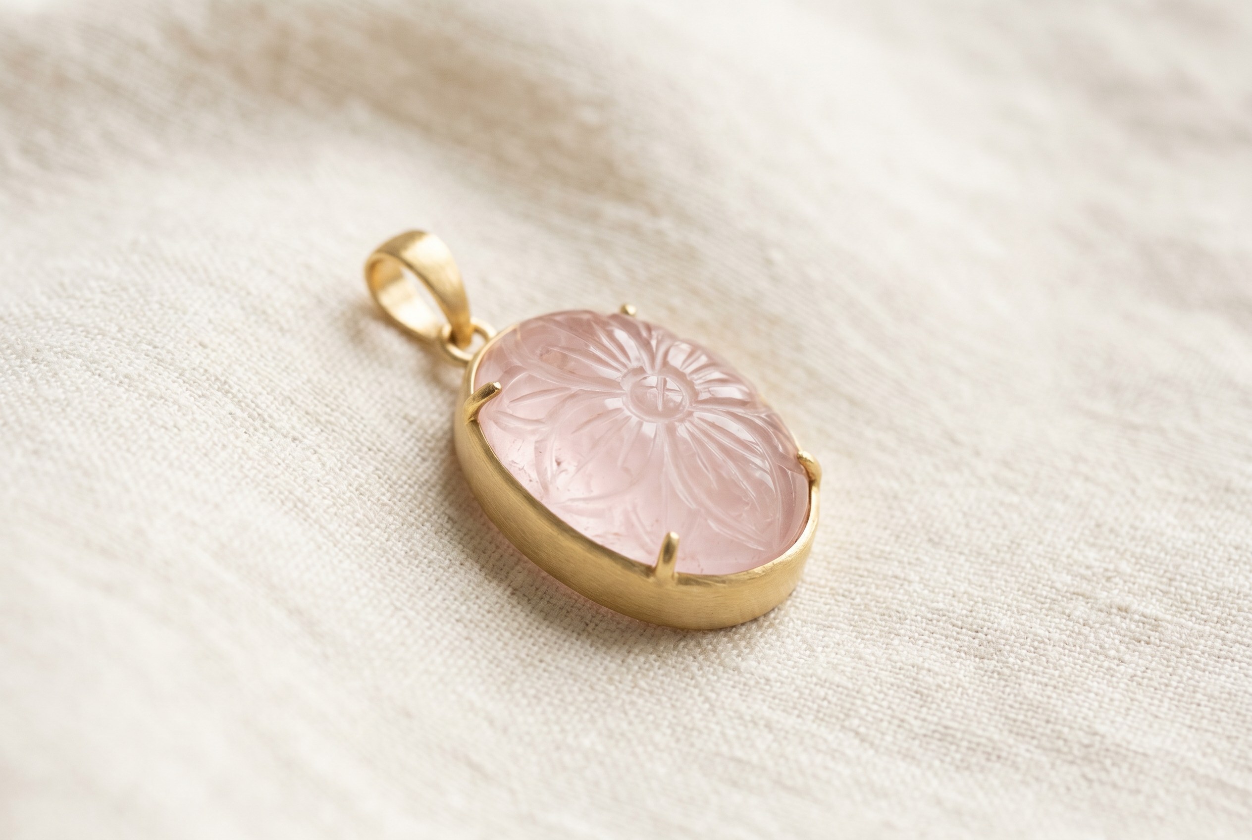 Carved rose quartz and gold pendant