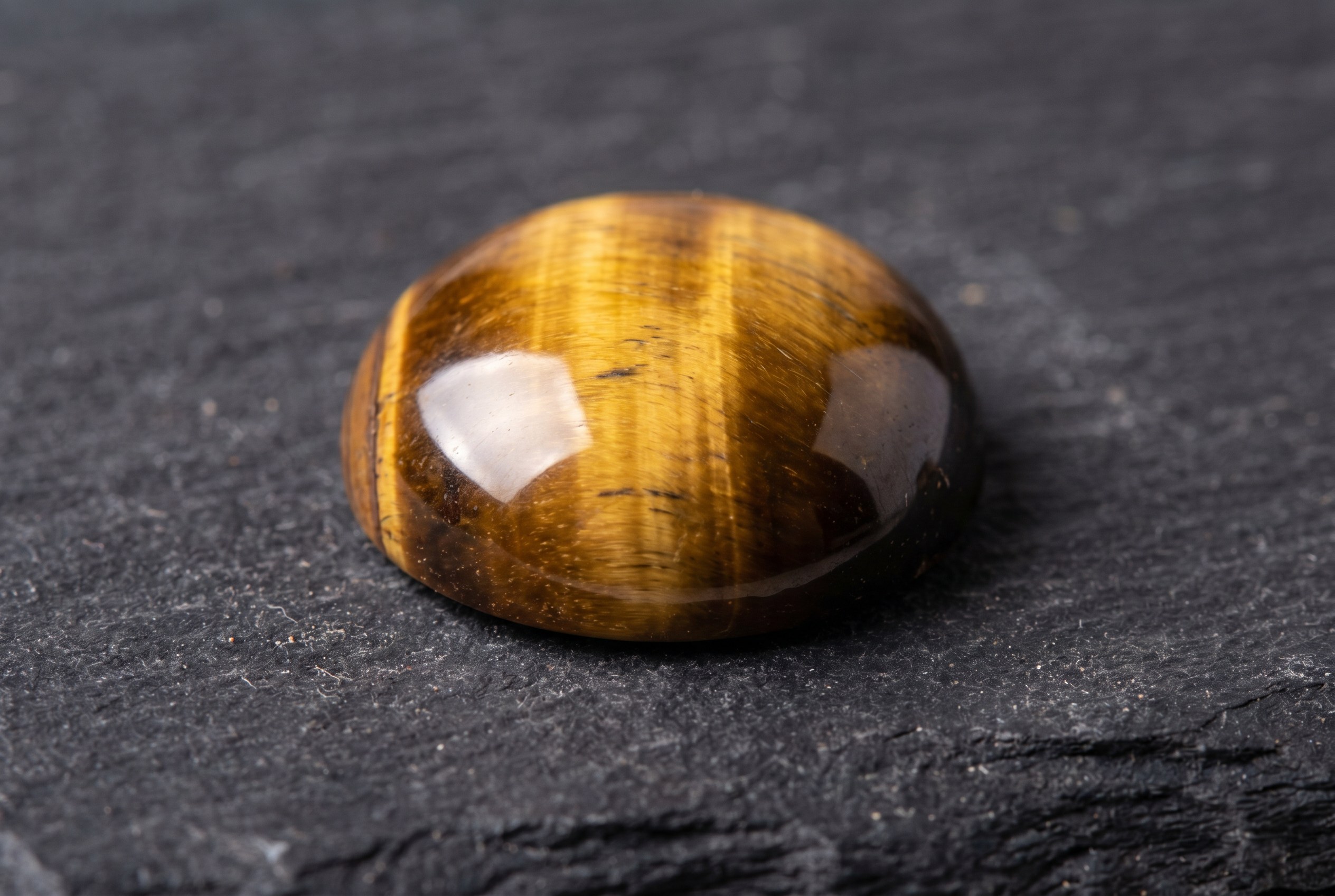 Polished tiger's eye cabochon showing chatoyancy