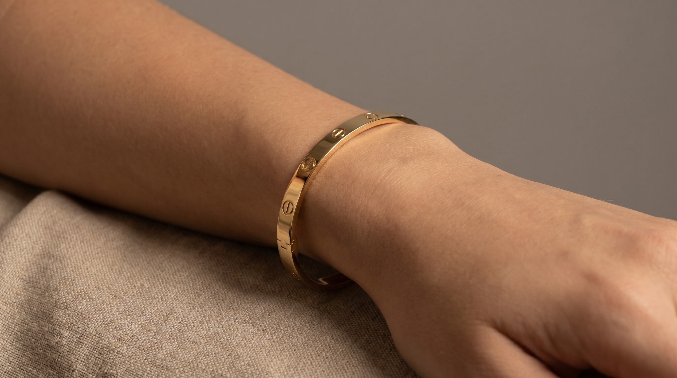 Cartier Love bracelet in 18ct gold worn on the wrist — Mozeris Fine Antiques