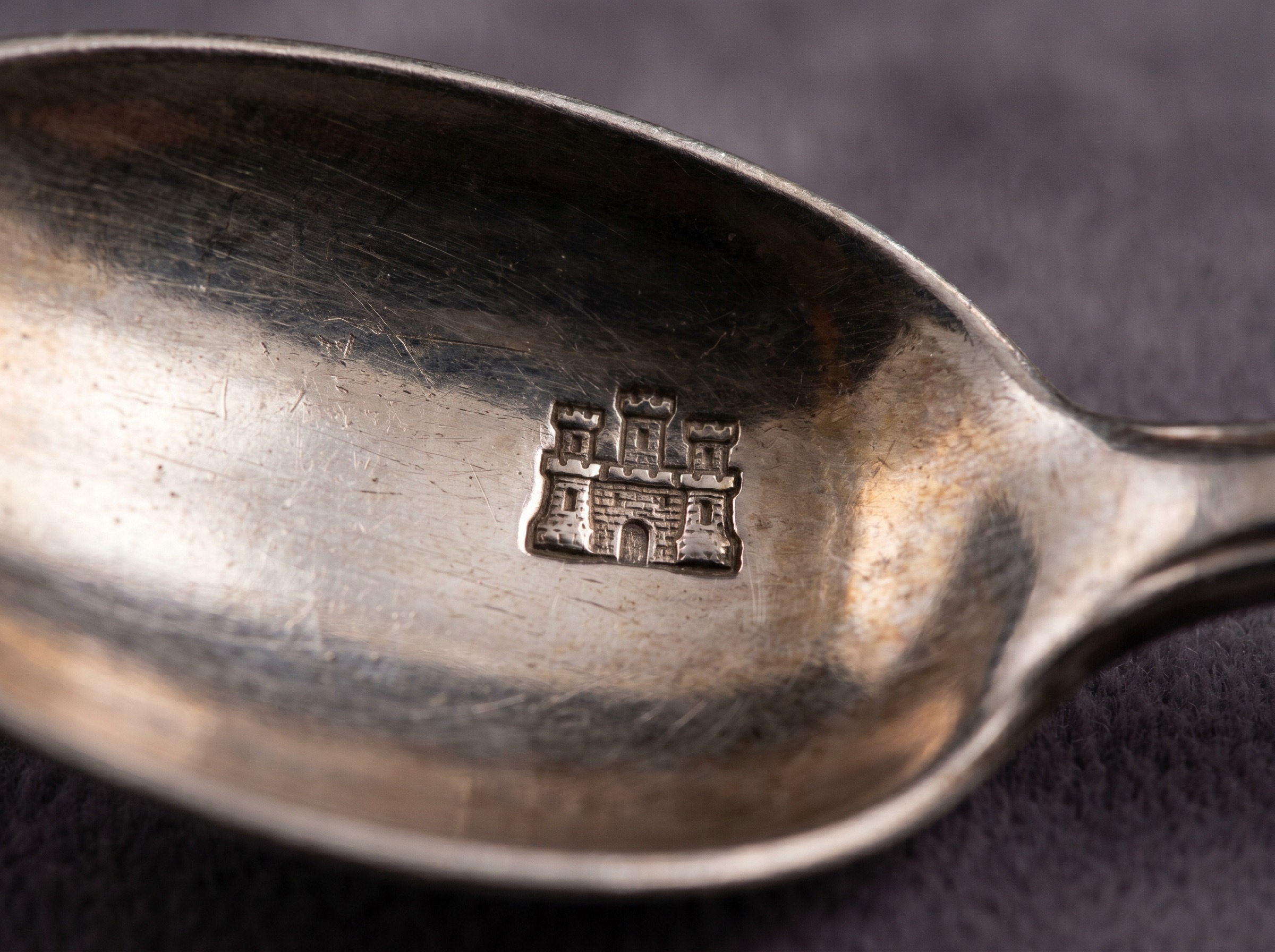 Extreme macro of Edinburgh Assay Office three-towered castle hallmark struck on Scottish sterling silver