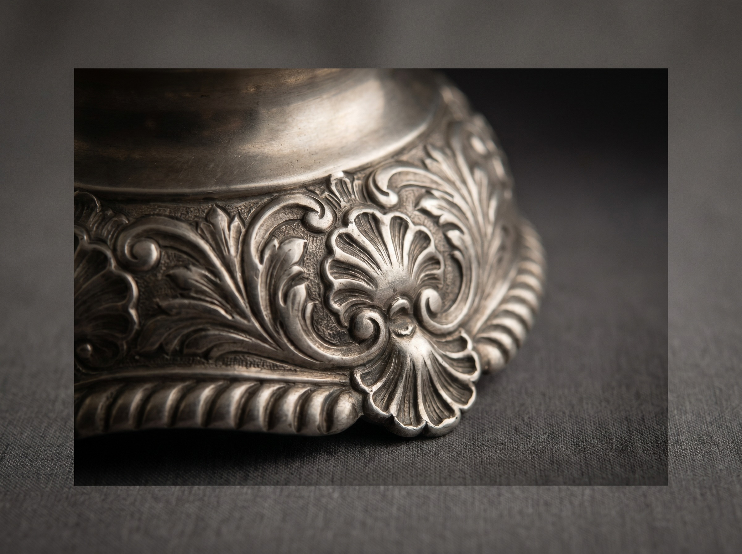 Extreme macro of heavy cast Rococo ornament on antique Georgian sterling silver — shells, gadrooning and scrollwork
