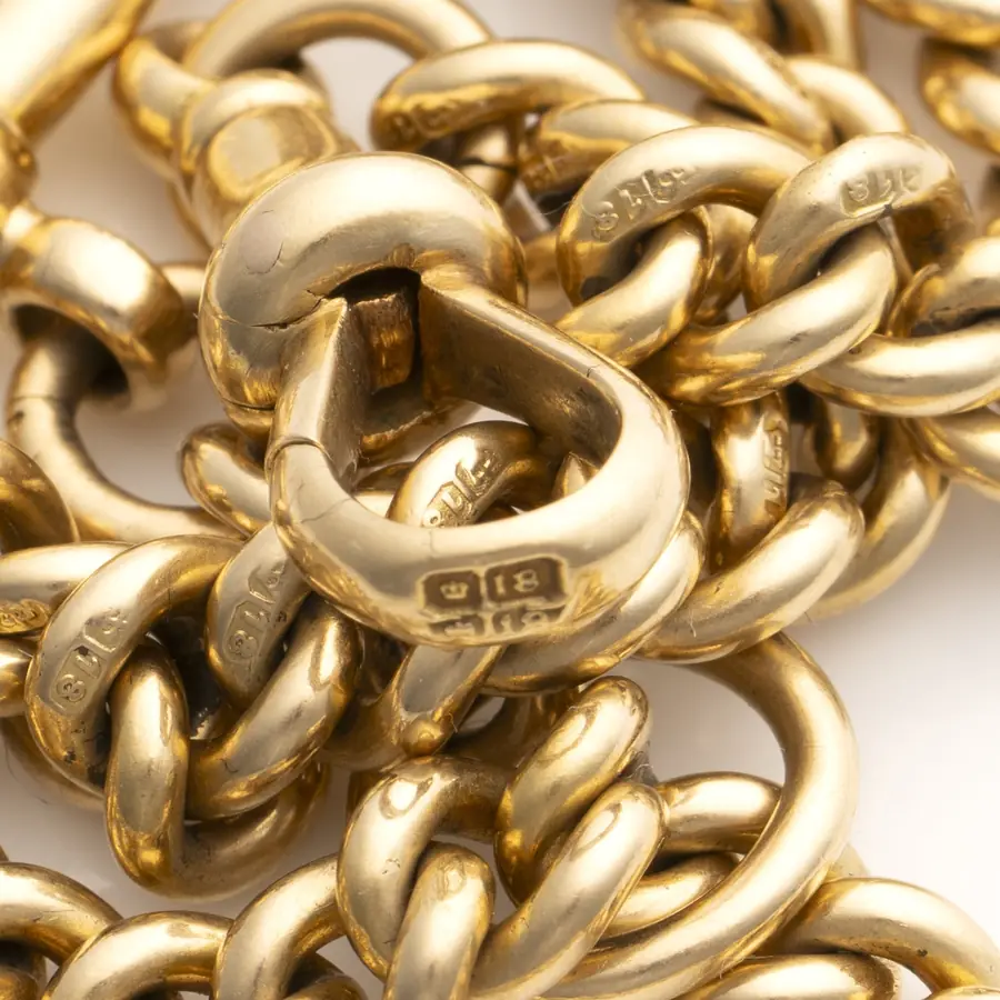Hallmarks struck on individual links of an Edwardian 18KT gold curb Albert chain
