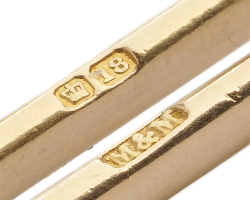 Crown and 18 hallmarks with the M&M maker's mark on the T-bar of an 18KT gold Albert chain