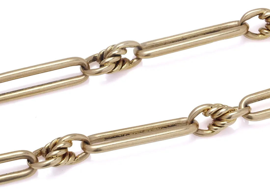 Trombone links, long bars joined by knot links, on an 18KT gold Albert chain