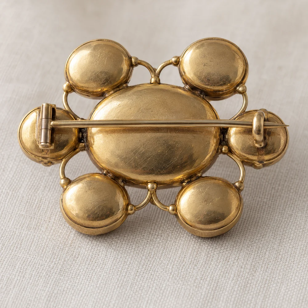 Illustration of the reverse of a Georgian style brooch: each stone enclosed in a closed gold back, with the pin across