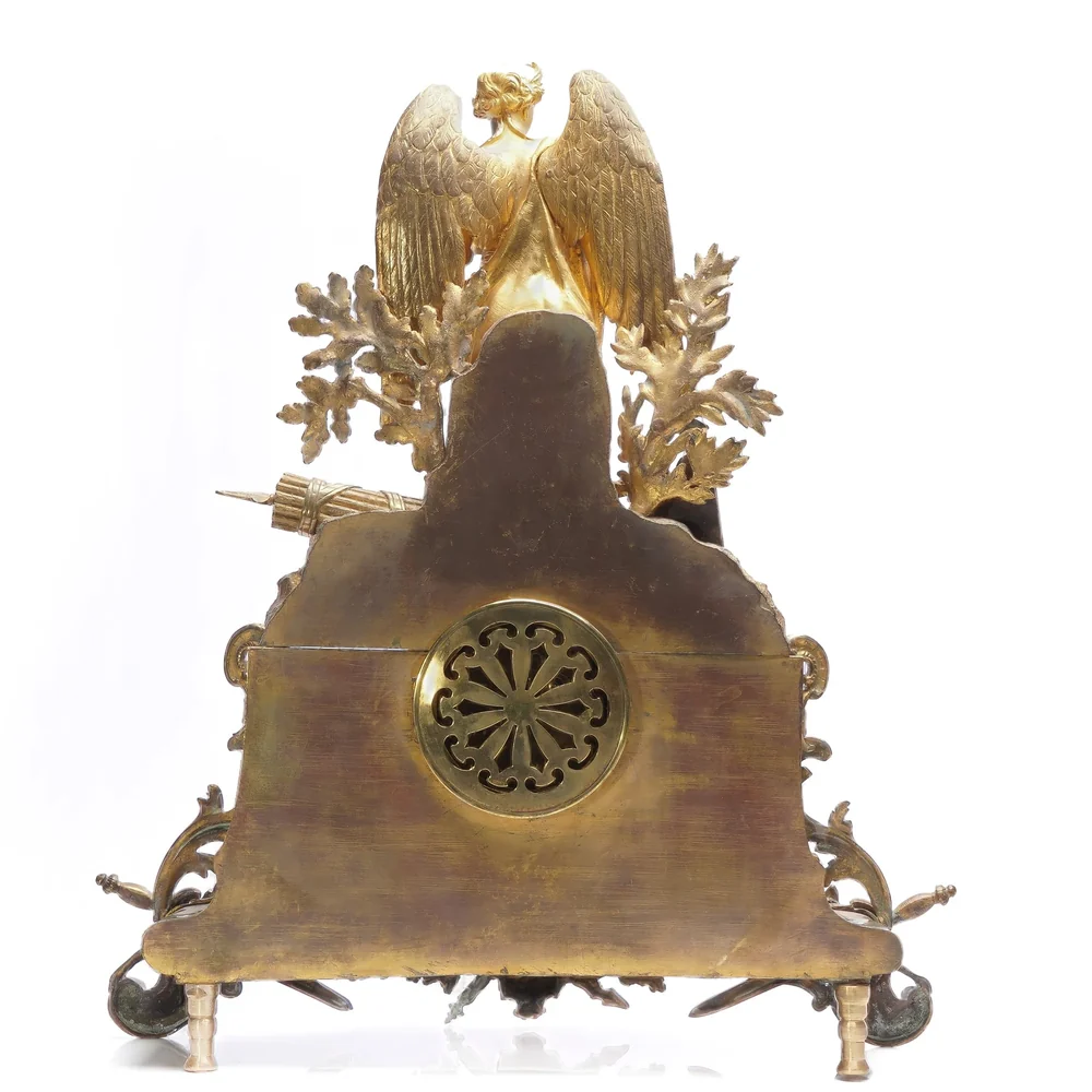Back of a French gilt bronze mantel clock with its pierced round back door closed, the view to photograph for a valuation