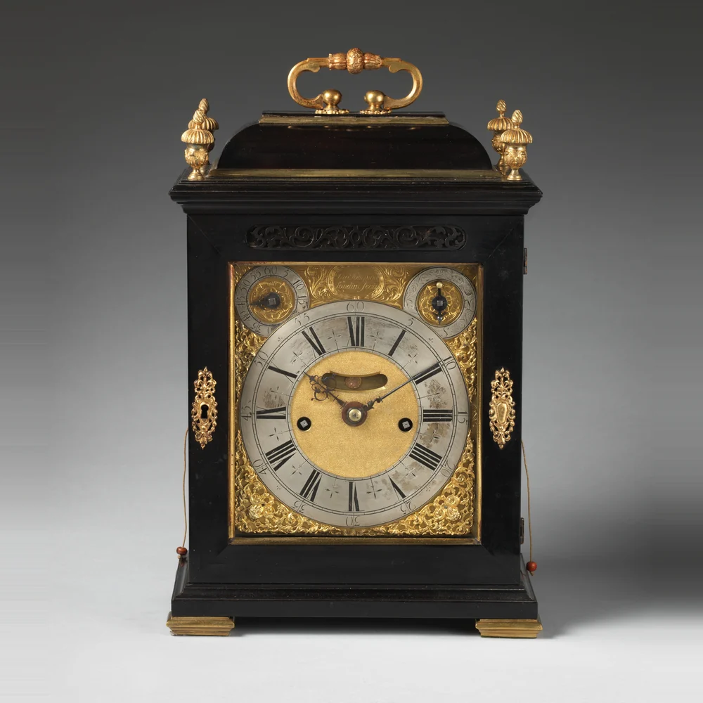 Ebony veneered English table or bracket clock by Thomas Tompion, London, about 1696, with gilt mounts and a carrying handle
