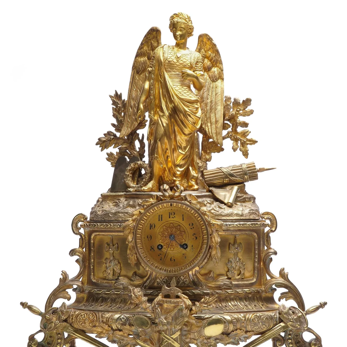 Antique 19th century French gilt bronze mantel clock with a winged allegorical figure above a gilt dial, on a scrolled base