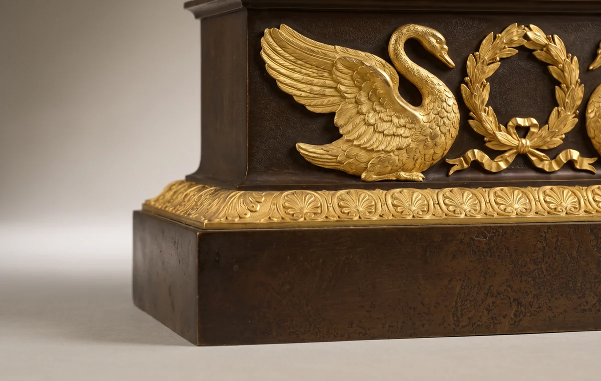 Gilt bronze swan, laurel wreath and palmette mounts on the dark patinated bronze plinth of a French Empire style clock