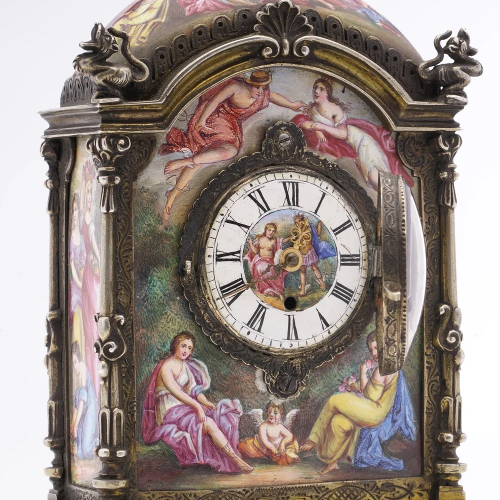 Viennese silver gilt clock of about 1880 by Hermann Ratzersdorfer with painted enamel panels of classical figures around a white enamel dial