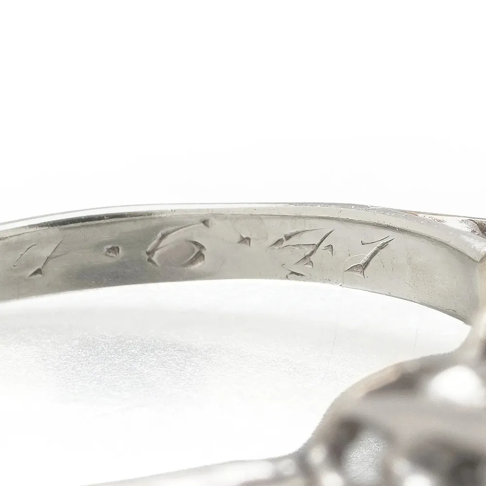 Date 4.6.47 engraved inside a three stone diamond ring