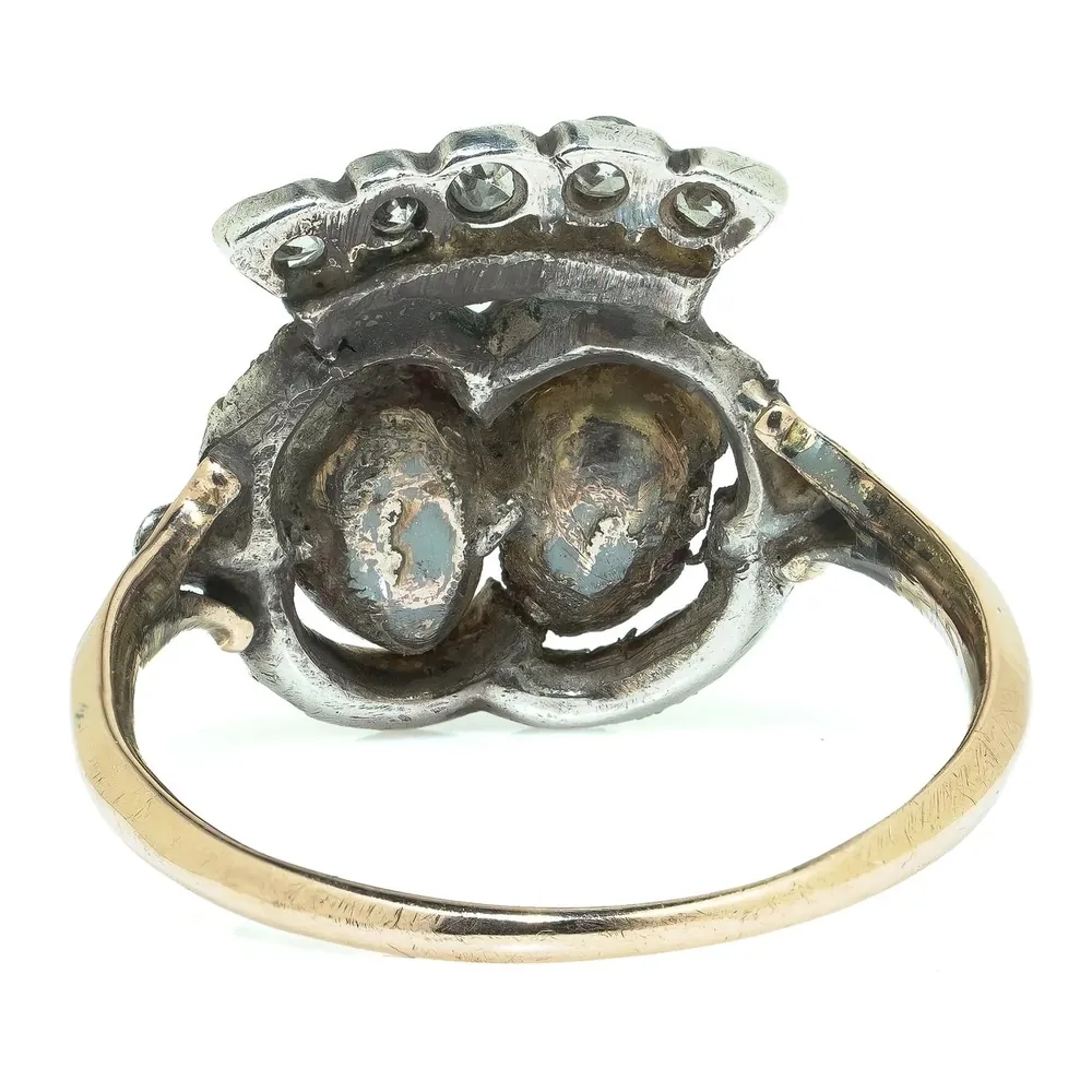 Closed-back settings behind a Georgian ruby and diamond cluster