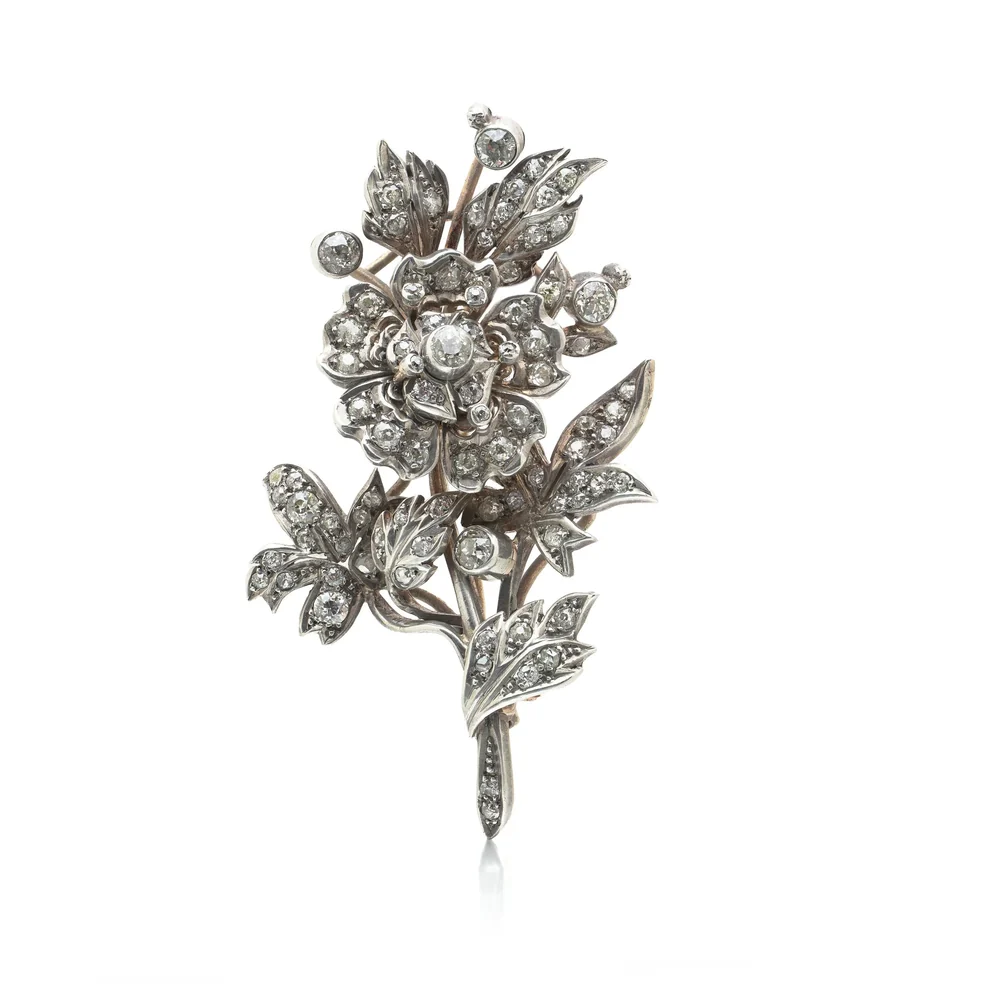 A Victorian diamond en tremblant flower spray brooch, old mine and rose cut diamonds in silver on gold, with a socket at the foot of the stem for fixing it to a tiara frame