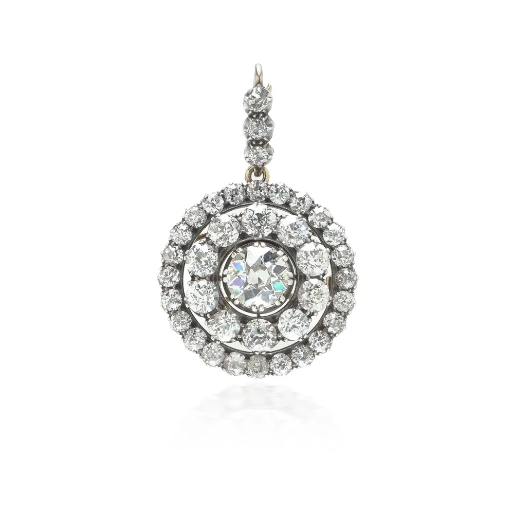 A Victorian old cut diamond double cluster pendant brooch in silver on gold, with a diamond set bail