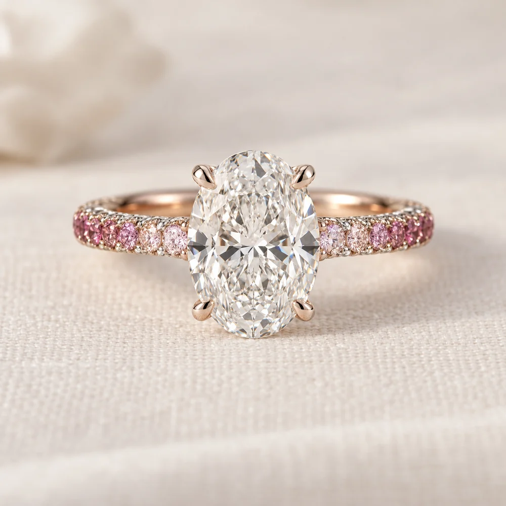 Illustration of a large oval diamond on a rose and white gold band set with pave diamonds shading from pale to deep pink