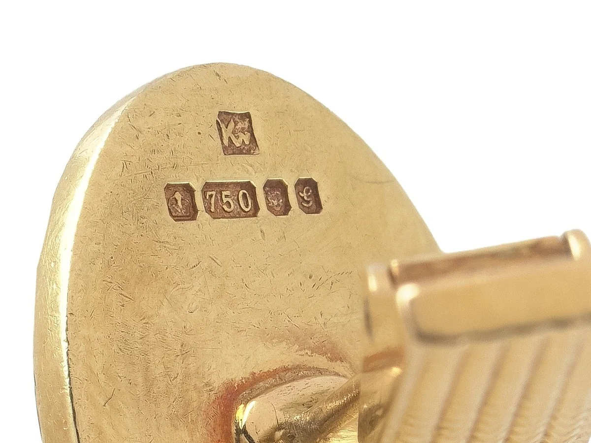 A full British hallmark with 750 for 18ct gold struck on the back of a gold cufflink