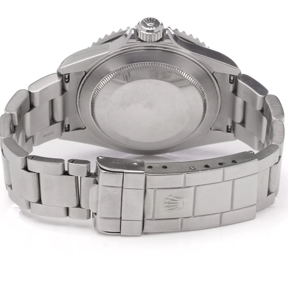 The plain, unengraved steel case back of a Rolex Submariner 16610LV on its Oyster bracelet
