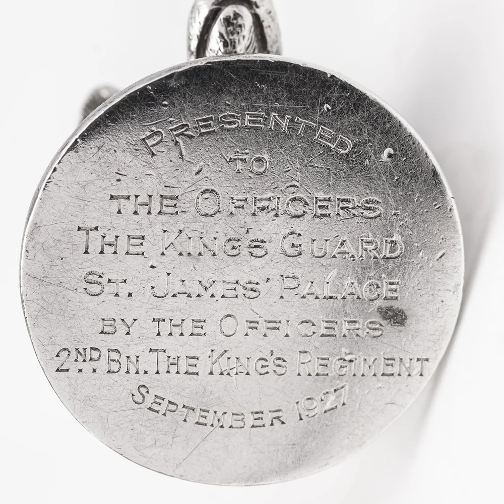 The base of a silver menu holder engraved Presented to the Officers The King's Guard St. James' Palace by the Officers 2nd Bn. The King's Regiment September 1927