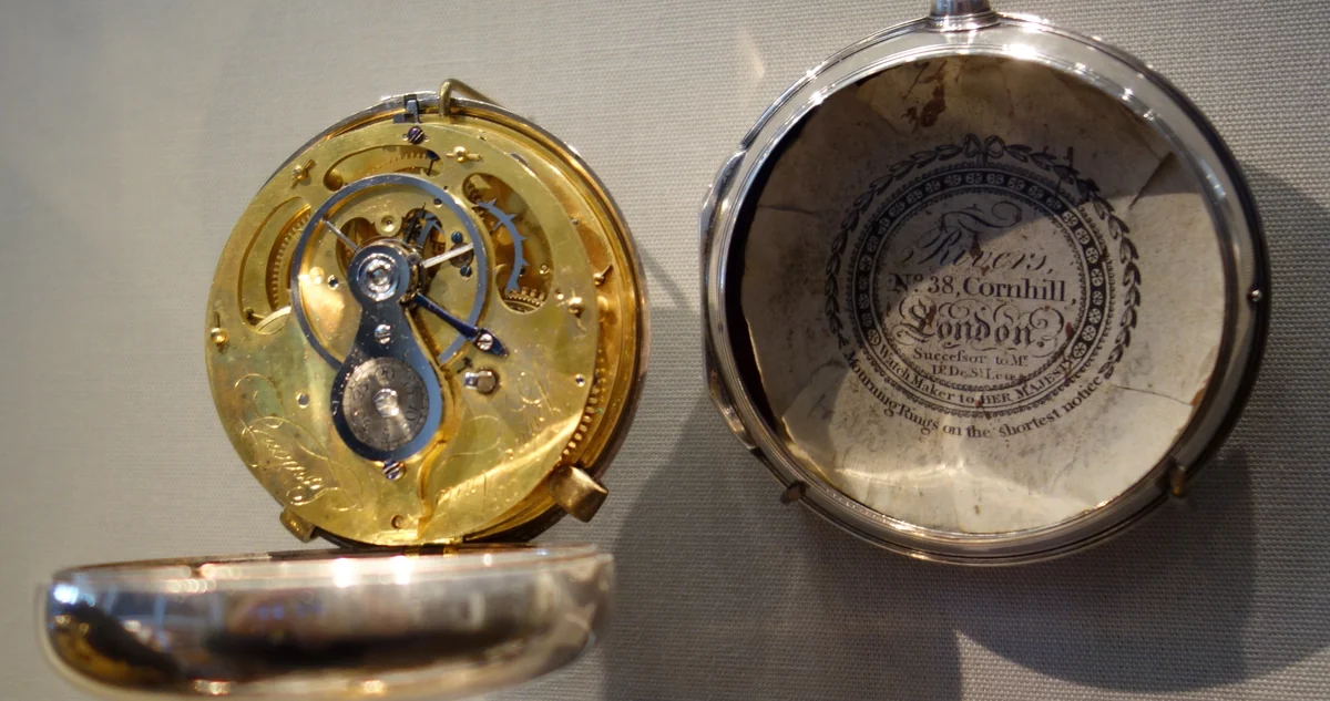 Silver watch by John Antes, London, hallmarked 1787 to 1788, movement open beside its case holding a printed watch paper of Rogers, 38 Cornhill, London