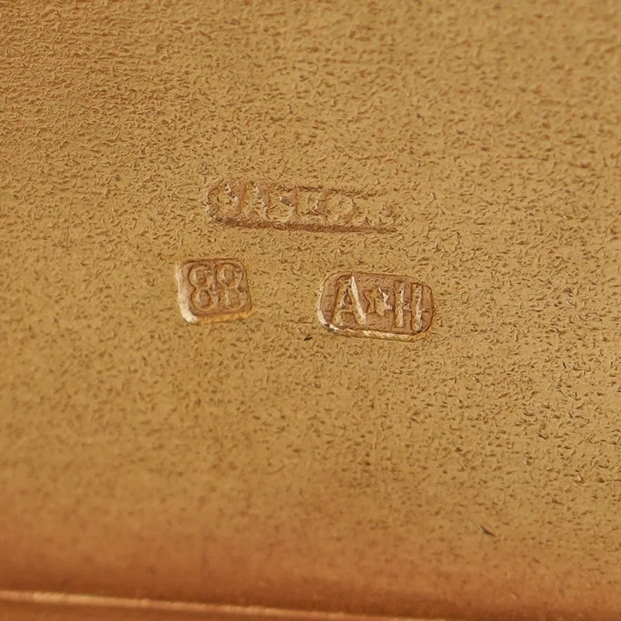 Marks inside a Faberge silver cigarette case: the Cyrillic signature FABERZHE, the 88 zolotnik standard and the workmaster's initials A star H