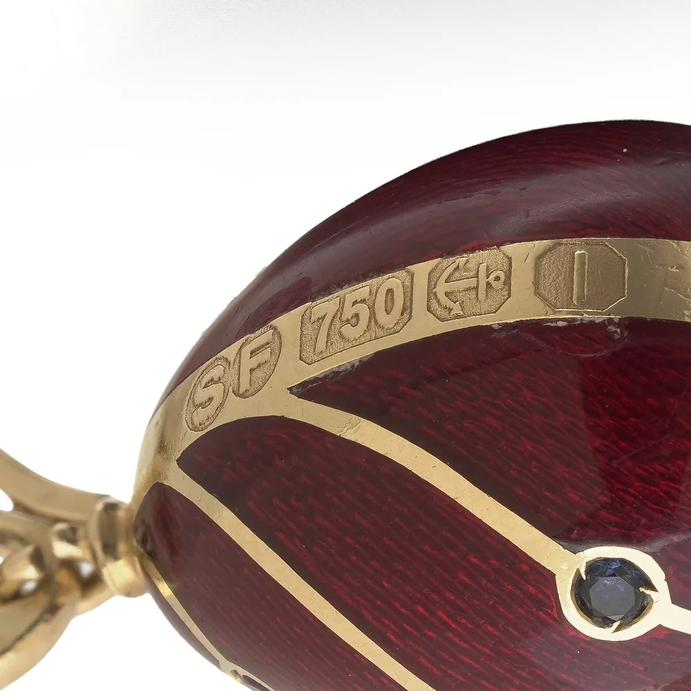 Marks on the gold band of the Sarah Faberge egg pendant: the SF maker's mark, 750 for 18KT gold and the Birmingham anchor assay mark