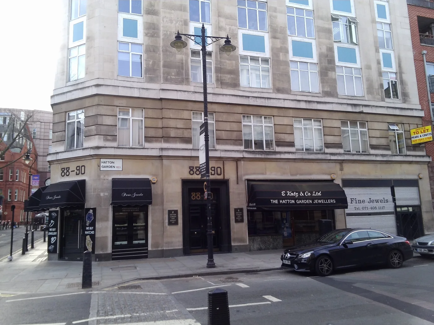 The corner building at 88-90 Hatton Garden, London, home of Hatton Garden Safe Deposit Ltd, with jewellers' shopfronts at street level, photographed in April 2014