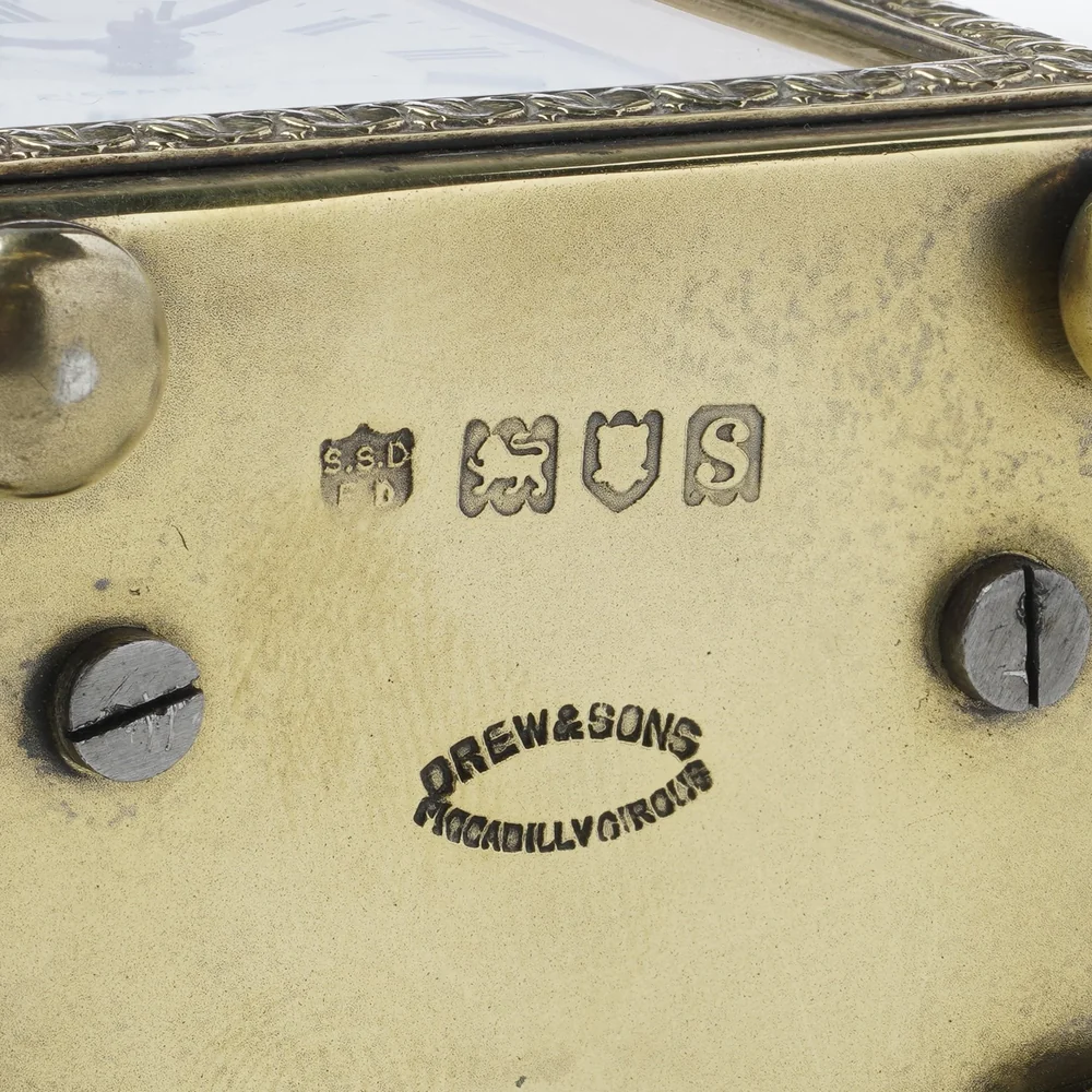 Underside of a silver-gilt carriage clock stamped Drew and Sons Piccadilly Circus beside London hallmarks