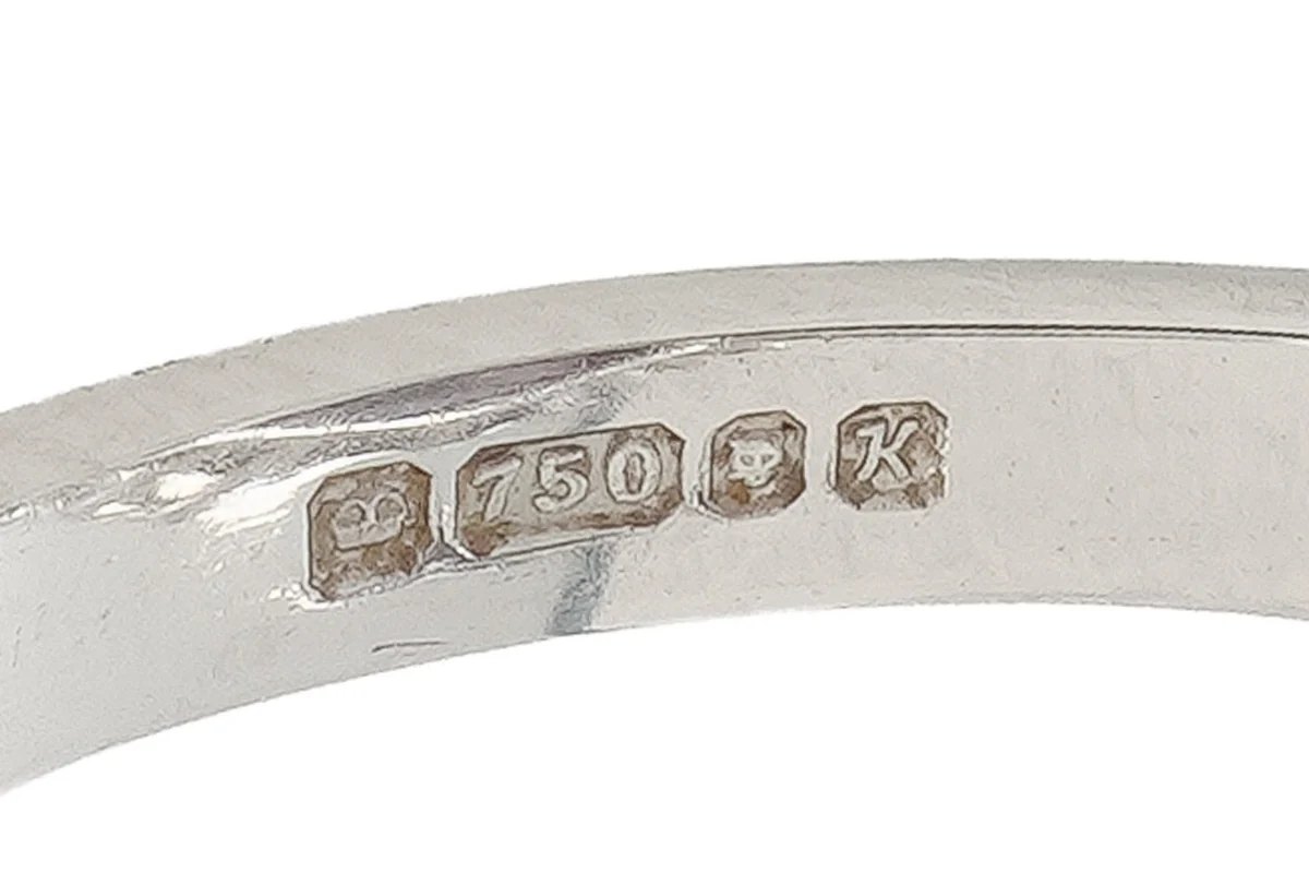 Hallmarks inside an English 18ct white gold ring: a crown, 750 in a shaped shield, the London leopard's head and the date letter K