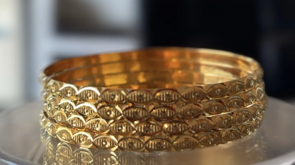 A stack of four patterned 22 carat gold bangles of the kind hallmarked 916