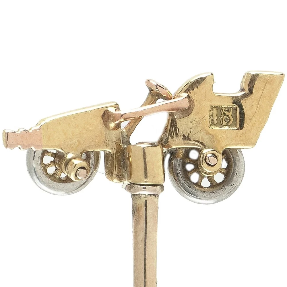 An antique gold motor car stick pin with a single 18 stamped on its side and no other marks