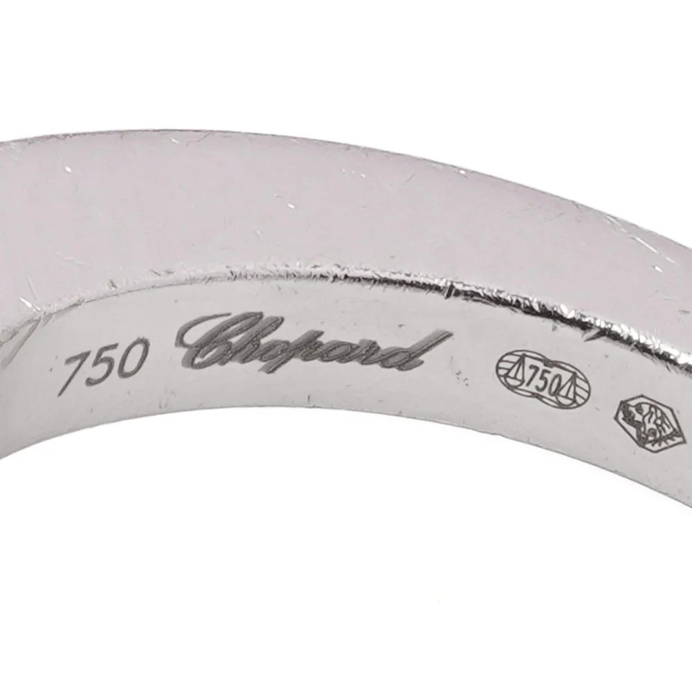 Inside a Chopard 18ct white gold ring: 750 and the Chopard name, beside a Common Control Mark with 750 at its centre and a further assay mark