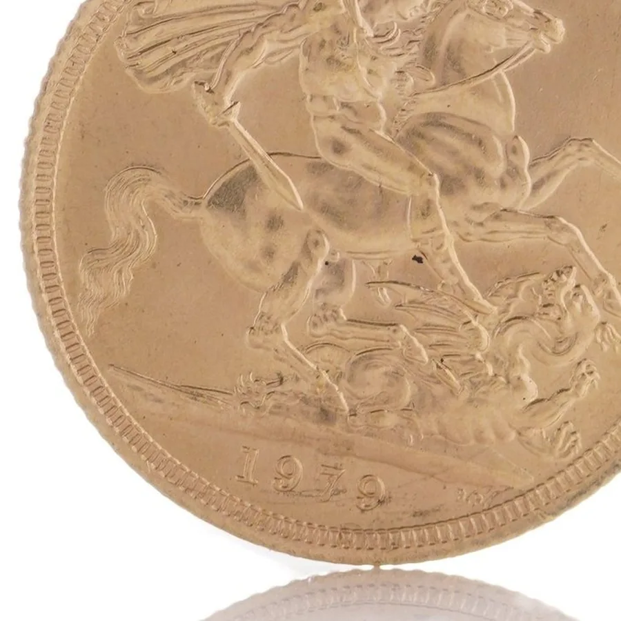 Close-up of the ground line and date 1979 on a gold sovereign reverse, with no mint mark letter above the date because it was struck in London