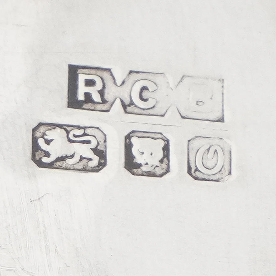 Silver hallmark on the base of a carriage clock: sponsor's mark RCB above the lion passant, the leopard's head of London and the date letter for 1988