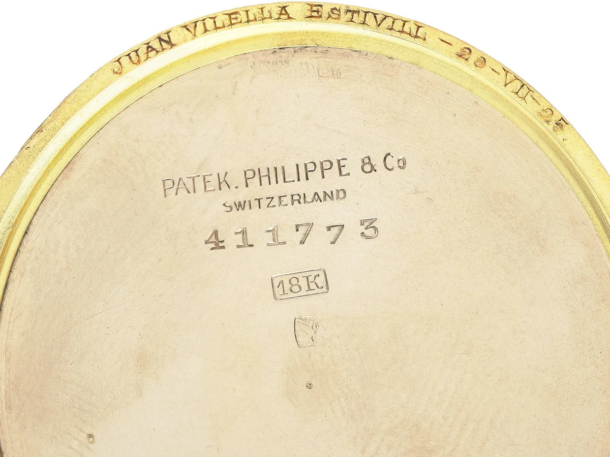 Inside the case back of a Patek Philippe pocket watch: case number 411773, 18K mark and an inscription dated 29 VII 25 on the rim
