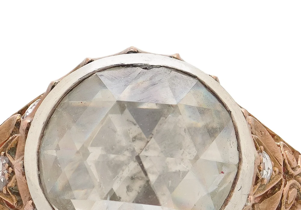 A large rose cut diamond in a Georgian ring, showing the domed crown of triangular facets in a collet setting
