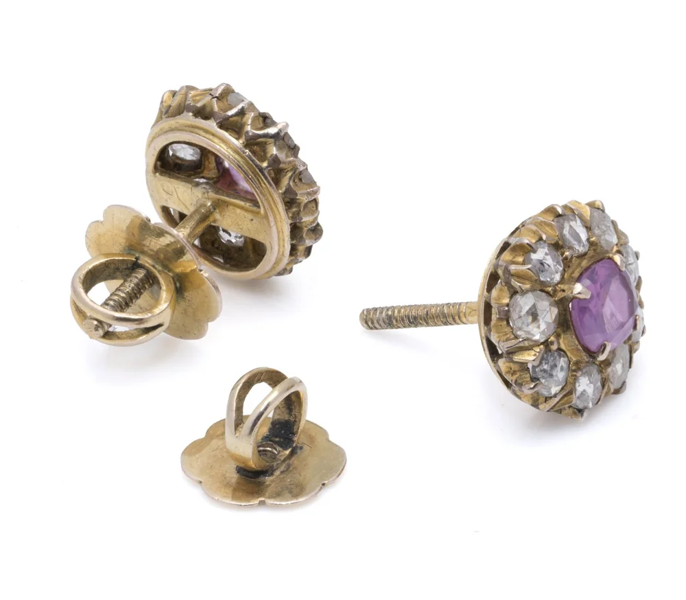 A pair of 9KT gold pink sapphire and rose cut diamond cluster earrings shown from behind with their threaded posts and screw backs removed