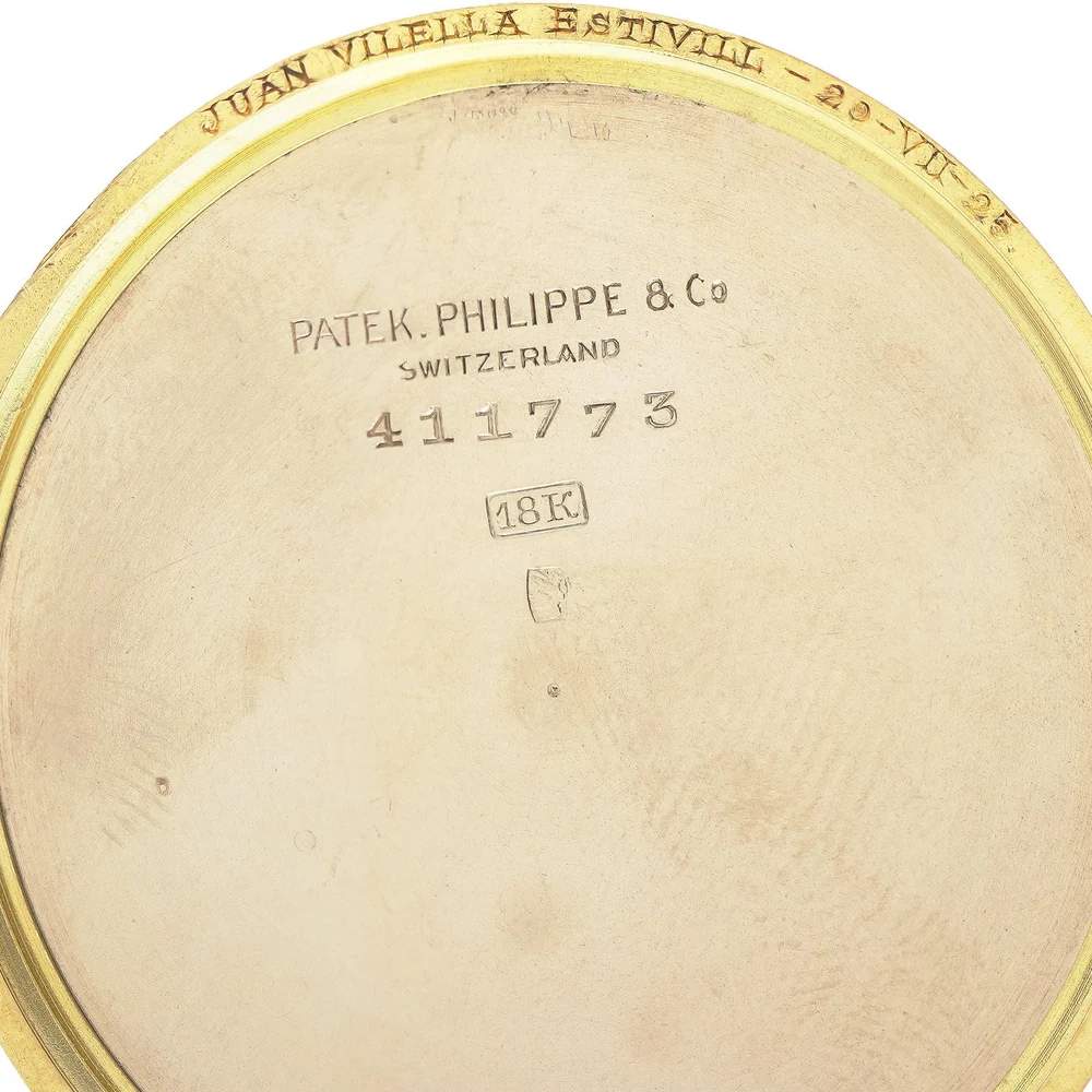 Inside of a Patek Philippe pocket watch case back stamped with the maker's name, case number and 18K
