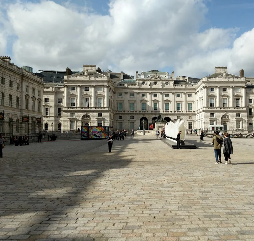 The courtyard of Somerset House in London, with its stone facades and a sculpture in the centre of the paved square